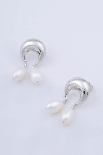 Pair of rhodium plated sterling silver earrings by Miro Miro, crafted in the shape of crescent moons, from which hang pairs of tear drop shaped natural freshwater pearls.