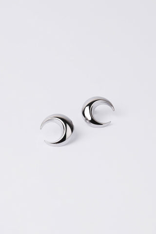 Pair of silver moon stud earrings on a light grey background.