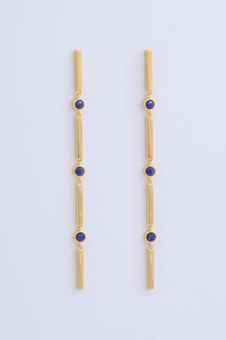 Pair of gold plated long drop earrings by Miro Miro. Featuring interlocking bars and natural lapis lazuli stones set in a bezel fitting.