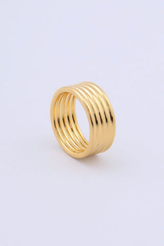 A gold plated ring by Miro Miro, featuring a ribbed textural finish on a thick band.