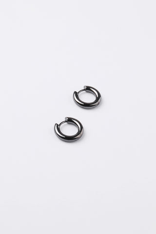 A pair of small black metal huggie hoop earrings on a clean white background.