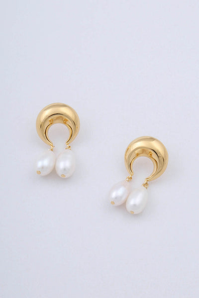 Pair of gold plated earrings by Miro Miro, crafted in the shape of crescent moons, from which hang pairs of tear drop shaped natural freshwater pearls.