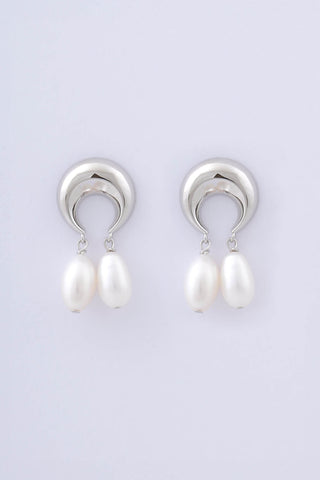 Pair of rhodium plated sterling silver earrings by Miro Miro, crafted in the shape of crescent moons, from which hang pairs of tear drop shaped natural freshwater pearls.