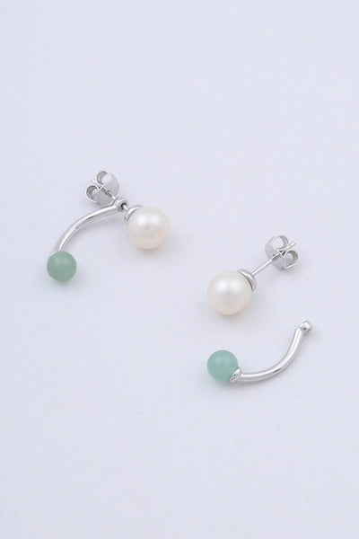 Model wears a singular freshwater pearl stud earring by Miro Miro.