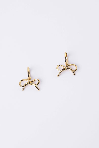A pair of gold bow-shaped stud earrings on a clean white background.