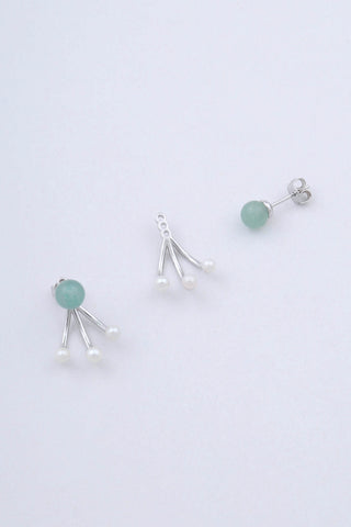 Pair of rhodium plated sterling silver earrings by Miro Miro, showing the spherical natural chrysoprase stud and removable ear jacket which features three freshwater pearls on a curved pronged finish.