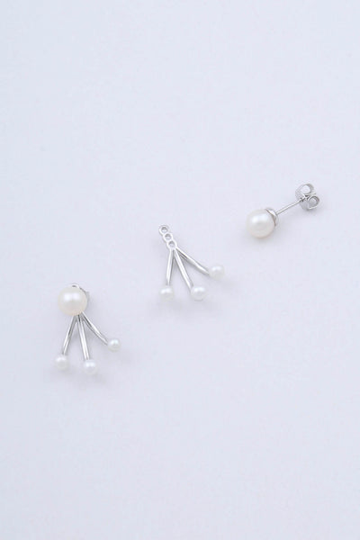 Model wears a freshwater pearl stud earring by Miro Miro.