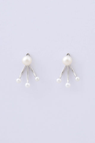 Pair of rhodium plated sterling silver earrings by Miro Miro, featuring a natural freshwater pearl stud, and an ear jacket with three matching freshwater pearls on a pronged finish.