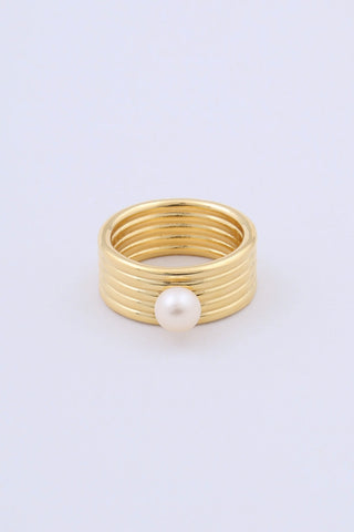 A gold plated ring by Miro Miro, featuring a freshwater pearl set on a thick band with a ribbed textural finish.
