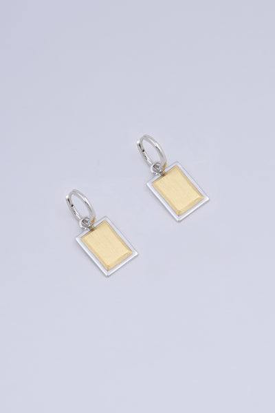 A pair of rectangular shape drop earrings, made in a two tone gold and silver finish.