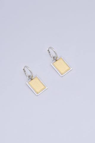 A pair of rectangular shape drop earrings, made in a two tone gold and silver finish.